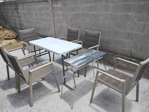 a group of chairs and a table and a table and chairs at Unwind DAY OFF Nagamo in Yaese