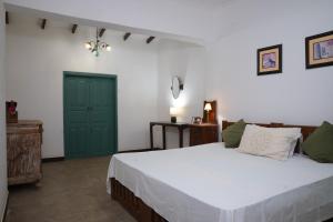 a bedroom with a bed and a green door at Aviyan Villa Wadduwa in Wadduwa