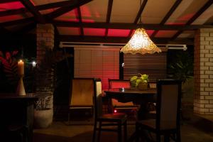 a dining room with a table and a chandelier at Aviyan Villa Wadduwa in Wadduwa
