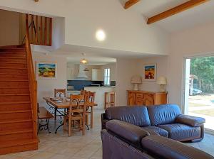 a living room with a couch and a table at Villa l Albatros - Coex in Coëx