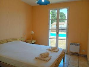a bedroom with a bed and a large window at Villa l Albatros - Coex in Coëx +11 photos