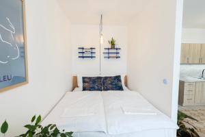 a small bedroom with a bed in a room at Atelier Lion in Žďár nad Sázavou