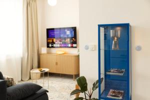 a living room with a blue refrigerator in front of a tv at Atelier Lion in Žďár nad Sázavou