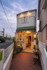 a building with a sign in front of it at ホワイトホテル鎌倉 in Kamakura