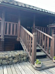 a porch of a house with two potted plants on it at Володимирська садиба in Migovo
