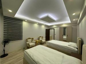 a hotel room with two beds and a ceiling at Göreme Apartment in Göreme
