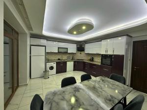 a kitchen with a table and chairs in a room at Göreme Apartment in Göreme