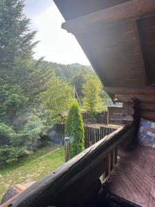 a balcony of a house with a view of a yard at Володимирська садиба in Migovo