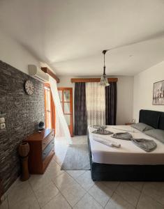 a bedroom with a bed and a living room at Sofia Villa in Astris
