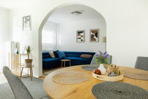 a living room with a table and a blue couch at Wildstein - Ferienwohnungen in Bayrischzell