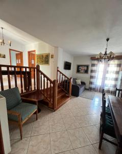 a living room with a staircase and a couch at Sofia Villa in Astris