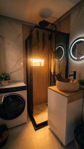 a kitchen with a microwave and a sink on a counter at Escapist Apartments in Niš +22 photos