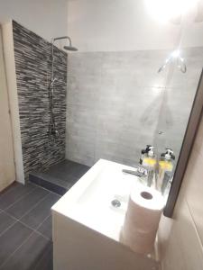 a bathroom with a white sink and a shower at Sarantakis Apartments in Agios Andreas +28 photos