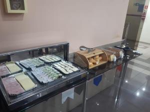 a buffet of food on a counter in a restaurant at SG Palace Hotel in Taubaté