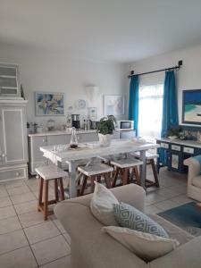a living room with a white table and chairs at Franmarel in Plettenberg Bay +31 photos