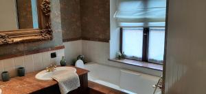 a bathroom with a sink and a bath tub at Les Tourelles in Contes