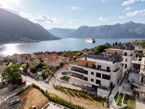 a city with a cruise ship in the water at Vrtovi Boke by Montena in Dobrota