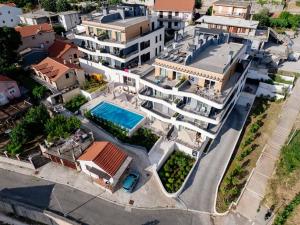 an aerial view of a building with a swimming pool at Vrtovi Boke by Montena in Dobrota
