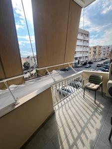 a balcony with a chair and a view of a street at Mamma mia rooms in Nola