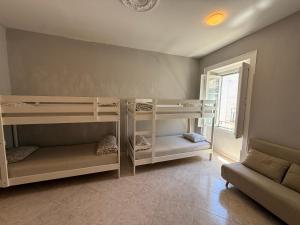a room with two bunk beds and a couch at Faro Coast Guest House in Faro