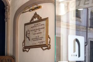 a picture hanging on the wall of a building at Hotel Antica Dogana in Turin