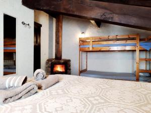 a bedroom with a bed and a fire place at Hotel Rural Bermellar in Bermellar