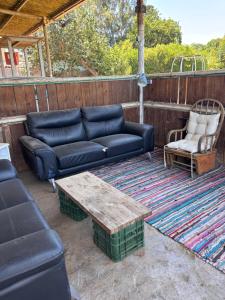 a couch and a coffee table on a patio at Green Bus in Beit Hillel