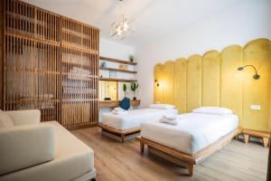 a room with two beds and a couch at Enjoy Palasa Comfy Villas in Palasë