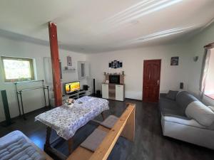 a living room with a couch and a table at BLTN House in Balatonalmádi