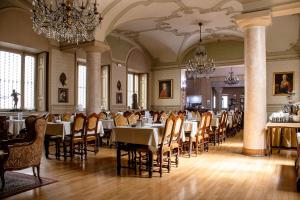 a dining room with tables and chairs and chandeliers at Hotel Antica Dogana in Turin +94 photos