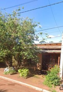 a house with a tree next to a street at Marcelo Buja in Jardín América