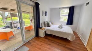 a bedroom with a bed and a sliding glass door at Meadow Sunrise in Bridgman +36 photos