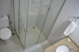 a bathroom with a shower and a toilet at SG Palace Hotel in Taubaté +20 photos