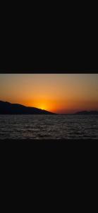 a sunset over a body of water at Hotel Dini in Vlorë +132 photos
