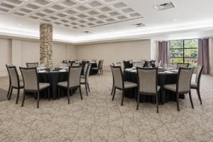 a banquet room with tables and chairs and a large window at Quality Inn and Conference Centre in Pembroke +44 photos