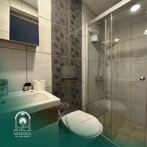 a bathroom with a toilet and a shower and a sink at Mad Sea Beach Hotel in Şile +13 photos