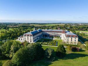 an aerial view of a large building on a field at Crowne Plaza Paris Marne-la-Vallée in Magny-le-Hongre