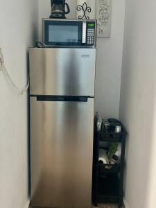 a microwave sitting on top of a refrigerator at Modern Apartment in Las Piedras in Las Piedras