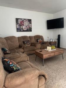 a living room with a couch and a coffee table at Modern Apartment in Las Piedras in Las Piedras