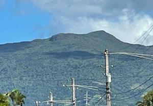 a mountain with a bunch of power lines in front of it at Modern Apartment in Las Piedras in Las Piedras