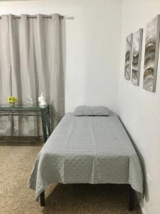a bedroom with a bed and a window at Modern Apartment in Las Piedras in Las Piedras