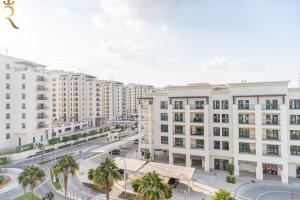 an aerial view of a city with tall buildings at Yas Island 1BR - Coastal Blue Haven in Abu Dhabi
