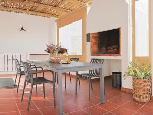 a dining room with a table and chairs and a fireplace at Fijnbosch Self-Catering Units in Jacobs Bay
