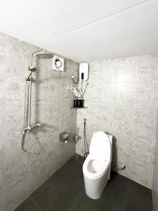 a bathroom with a toilet and a shower at Feeali Buddies Inn in Maldive Islands