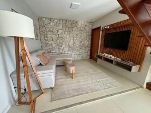 a living room with a couch and a tv at Charming house in countryside in Brotas
