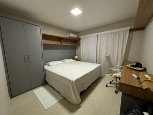 a bedroom with a bed and a desk and a chair at Charming house in countryside in Brotas +30 photos