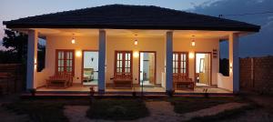a home with a porch with chairs and lights at Hungry Wave in Arugam Bay