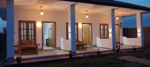 a home with a porch with chairs and lights at Hungry Wave in Arugam Bay +17 photos