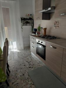 a kitchen with a stove and a counter top at casa vacanza Lu Murajon in Dogliola