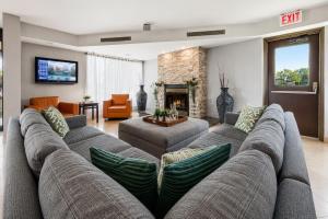 a living room with a large couch and a fireplace at Quality Inn and Conference Centre in Pembroke